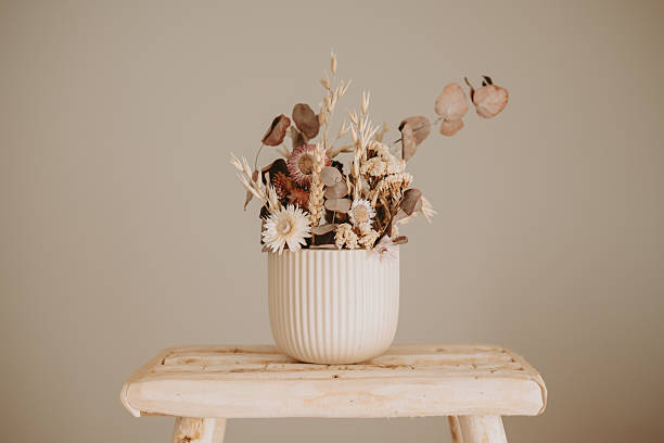 istock Ceramic vase and wooden stool in a neutral interior 2249829878