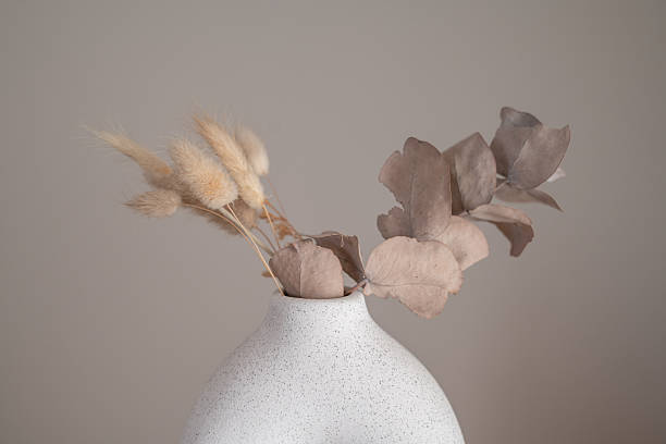 istock Ceramic vase and wooden stool in a neutral interior 2249829892