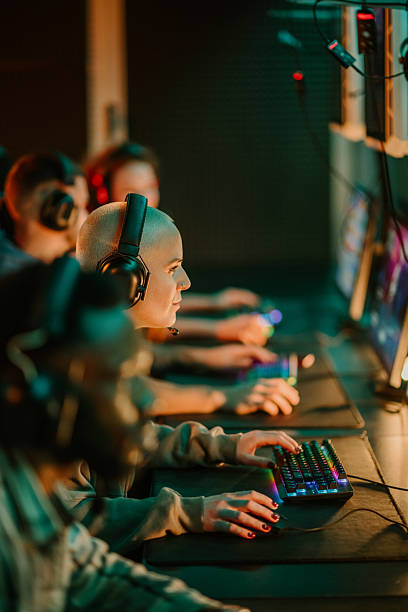 istock Woman gamer wearing headset playing video game on computer 2249833038