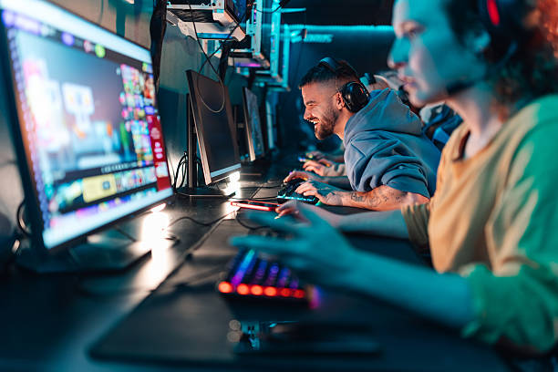 Gamers finding joy in esports competition, wearing headphones, and using computers with colorful keyboards in a vibrant internet cafe