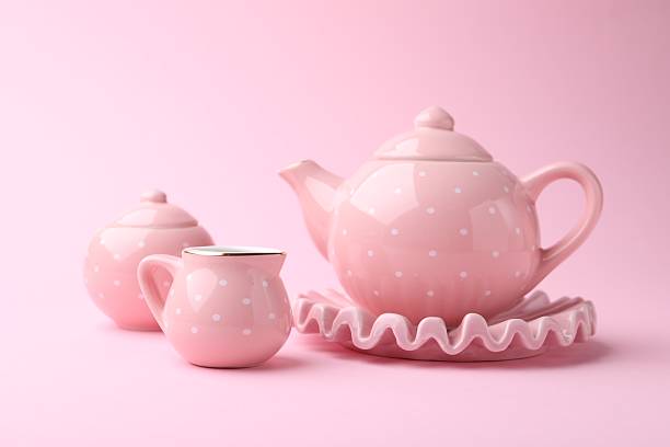 Beautiful tea set on pink background. Child's toy