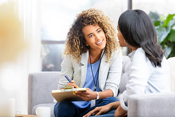 istock Mental health professional attentively listens to a patient while taking notes during a counseling session. 2249834768