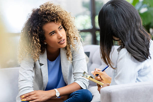 istock Two women in a counseling session, one taking notes, discussing mental health 2249834774