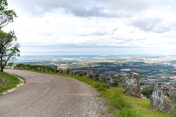 istock Mountain road with stone barriers overlooking rural valley 2249838340