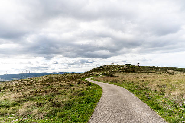 Curving hill road leading to windmills in Serra de Montejunto