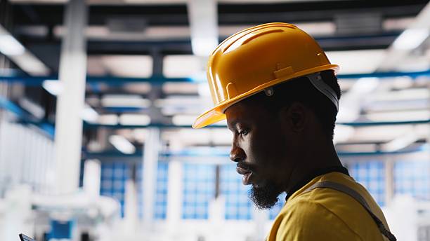 istock Black technician in solar panel facility reviews photovoltaic system performance 2249841257
