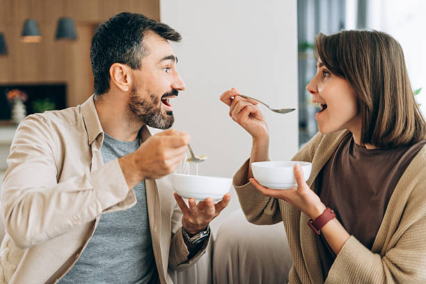 istock Happy couple enjoying fun breakfast together at home 2249841706