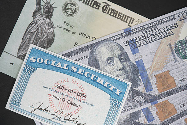 istock Fake Social security card on prop US currency and check 2249849251