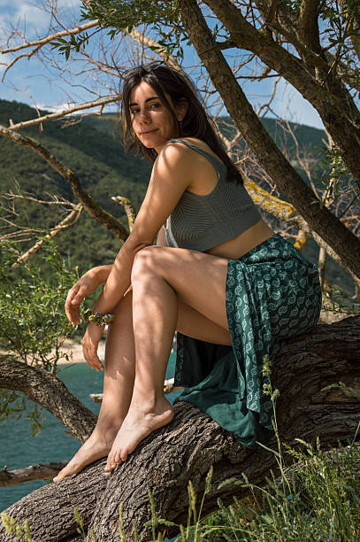 Young female heroine day dreaming during summertime in rainforest.