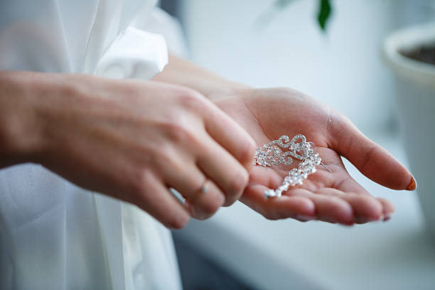 istock bride puts on wedding jewelry on the wedding day 2249857742