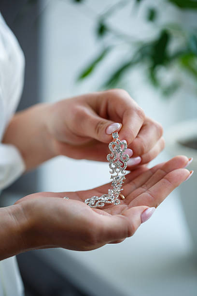 istock bride puts on wedding jewelry on the wedding day 2249857821
