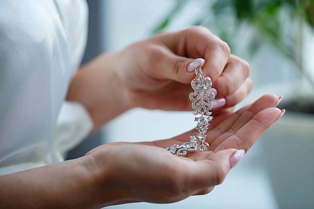 istock bride puts on wedding jewelry on the wedding day 2249857872