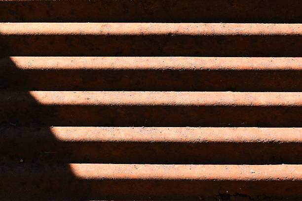 old zinc metal roof background with sunlight, construction industry
