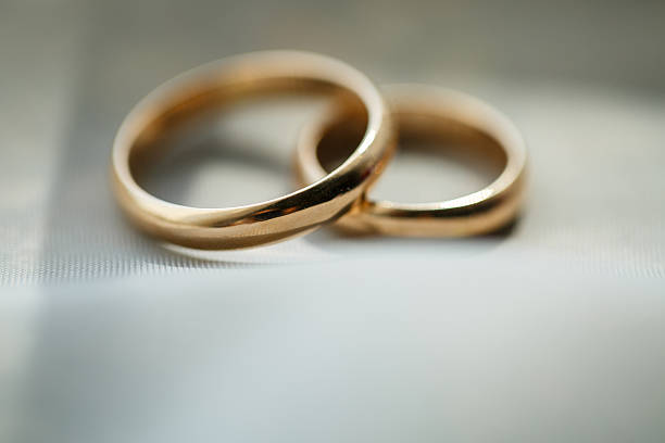 istock Gold wedding rings for newlyweds on wedding day 2249860281