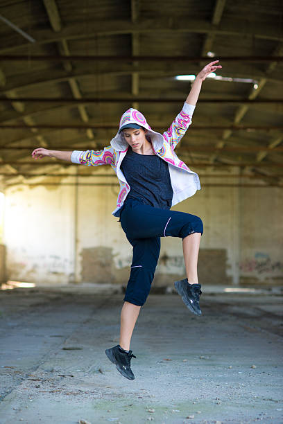 istock Young female hip hop dancer dancing in abandoned building 2249866763