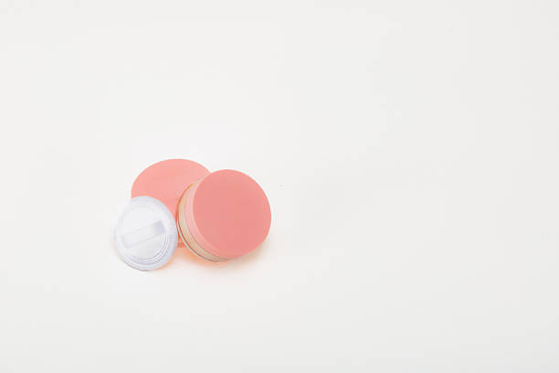 This image showcases a pile of fine pink cosmetic powder against a white background, highlighting its soft texture and color, perfect for enhancing beauty through makeup.