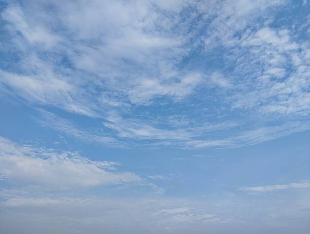 istock clear blue sky with a few clouds. The sky is very bright and the clouds are scattered throughout 2249870289