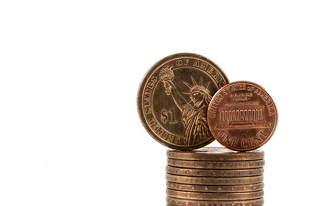 istock US $1 coin and 1 American cent coin  on a white background 2249870425