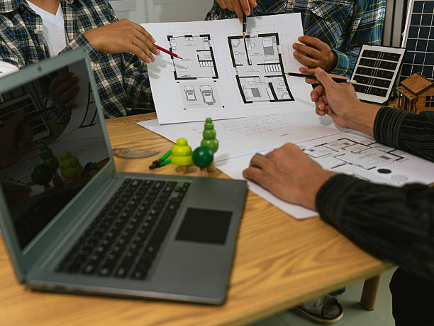 istock Architects and engineers work on blueprints at their desks, designing independently, covering everything from preliminary project sketches, construction drawings, architectural designs. 2249871229