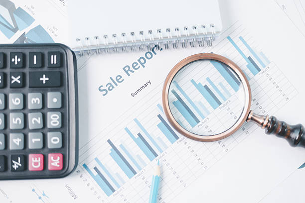 istock Magnifying glass with calculator and pen on financial reports with charts, graphs at office desk. Concept of business analysis, accounting audit, financial accuracy, transparency, corporate strategy. 2249873708