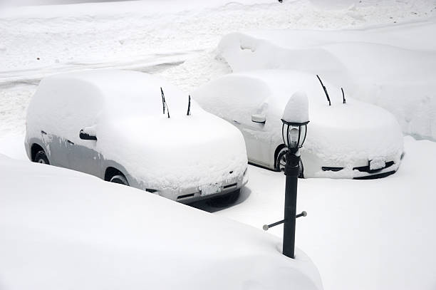 istock snow covered car on the driveway in winter 2249877229