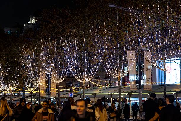 Paris, France - November 16, 2025: Champs-Elysees in Paris illuminated for Christmas and Triumphal Arch in background
