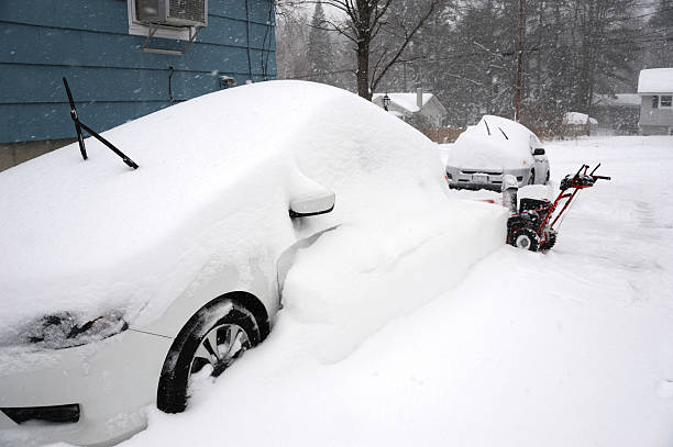 istock snow covered car on the driveway in winter 2249883095