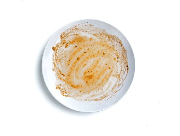 Dirty white plate with leftovers food  isolated on white background. Flat lay