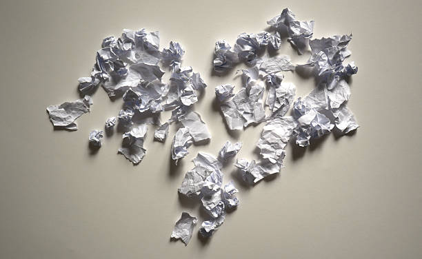 istock Conceptual photo a broken heart shape made from crumpled white paper scraps on a light background. Minimalism texture. 2249883624