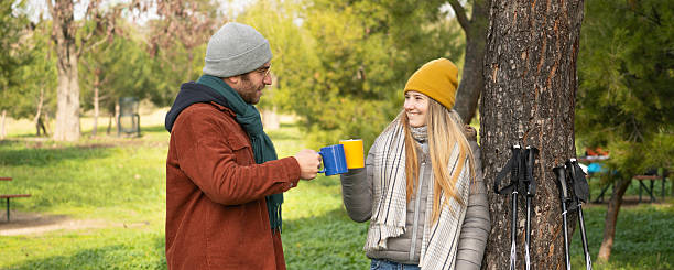 istock Hikers toasting with hot drinks after hiking in nature 2249884965