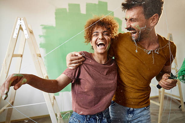 istock Cheerful couple embracing while painting their new home. 2249886011