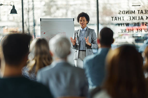 istock Happy black female leader talking on presentation in the office. 2249887115