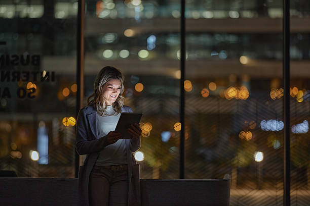 istock Happy businesswoman using touchpad late in the office. 2249887601