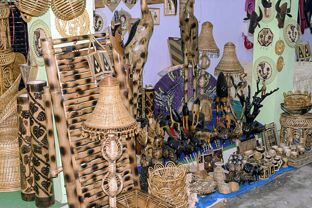 newtown, kolkata, india- december 03, 2025: rich display of bamboo lamps, walking sticks, carved animal figures, woven baskets and decorative wall pieces at kolkata handicraft fair stall