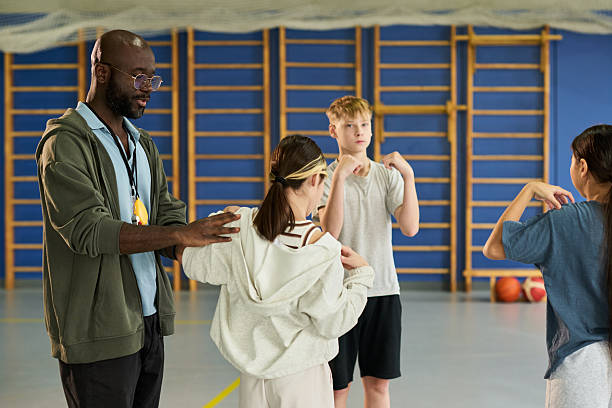 istock Black Man Instructing Diverse Teenagers during Gym Class 2249892074
