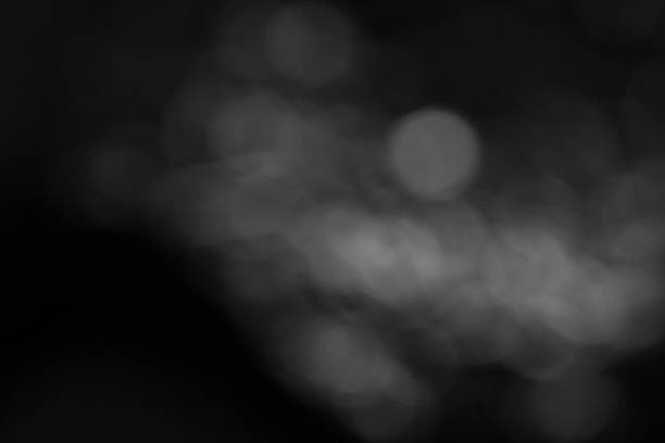 Abstract black and white bokeh light background with soft circular blur. Ideal for design, mood, texture, and minimalist themes.