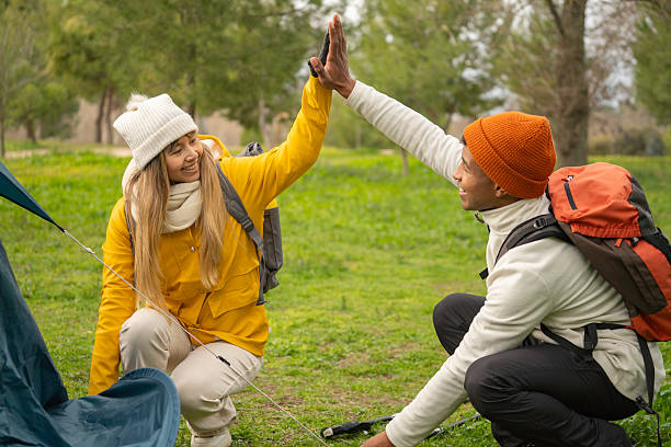 istock Hikers giving high five while setting up tent in campground 2249894338