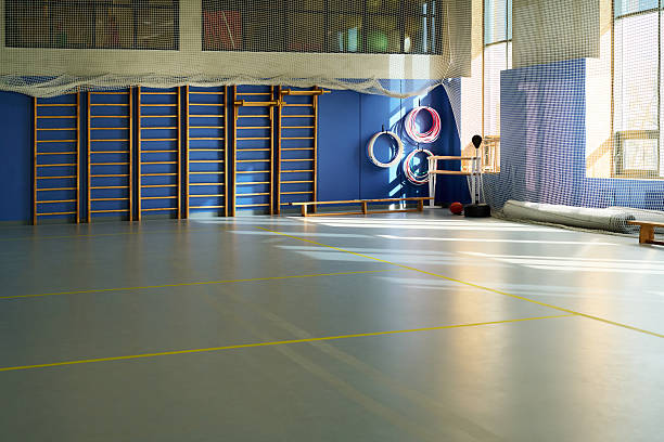 istock Empty Gymnasium with Sunlight Streaming Onto Floor during Daytime 2249894516