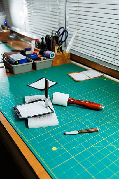 istock A work table for the manufacture of products from genuine leather. Tools for manual leather work 2249895085