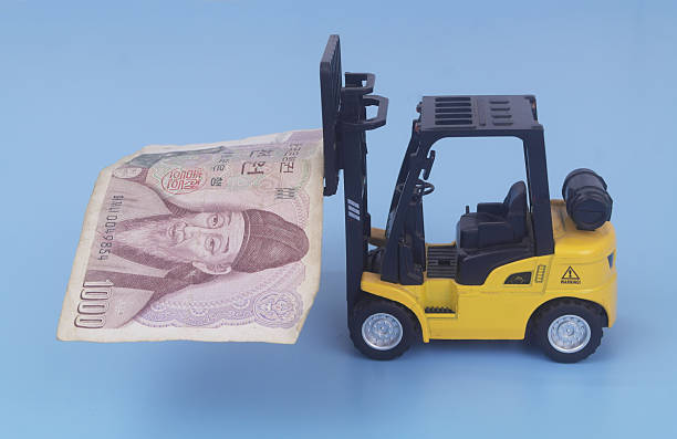Yellow forklift carrying Korean wons on blue background