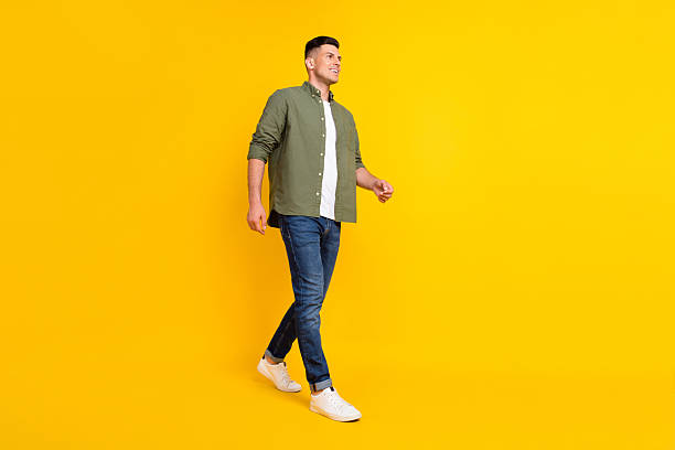 istock Full length body size photo guy walking forward looking copyspace isolated vibrant yellow color background 2249899775