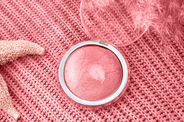 Blush compact on pink knit with delicate feathers and starfish detail