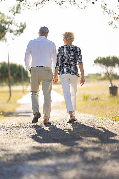 istock Senior couple holding hands walking future path 2249905243