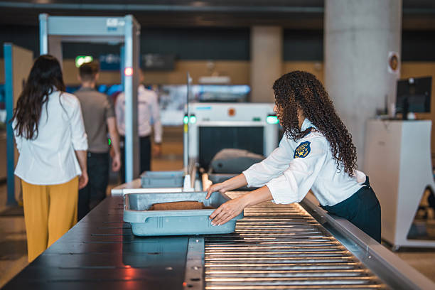 istock Young Hispanic Female Airport Security Worker Checking Luggage at Security Conveyor Belt 2249905317