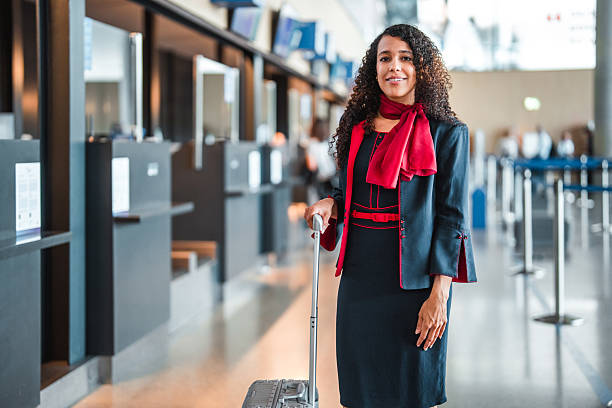 istock Young Hispanic Stevardese Ready for Airport Duties with Luggage 2249905676