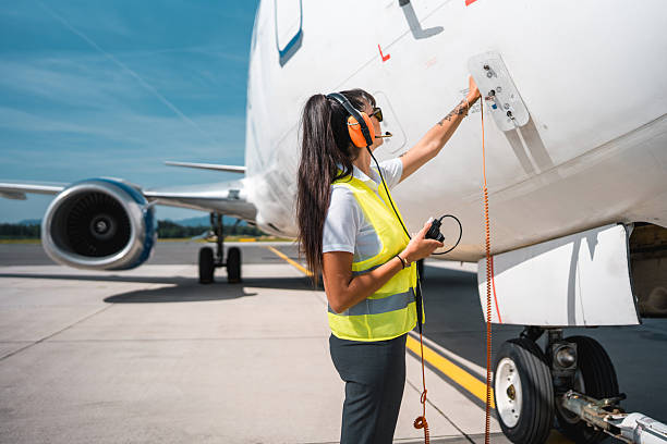 istock Female Ground Support Staff Connecting Headset to Cargo Aircraft 2249905890