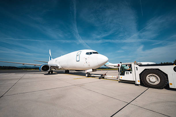 istock Cargo Aircraft Being Hooked by Pushback Tug at Airport Ramp 2249905975