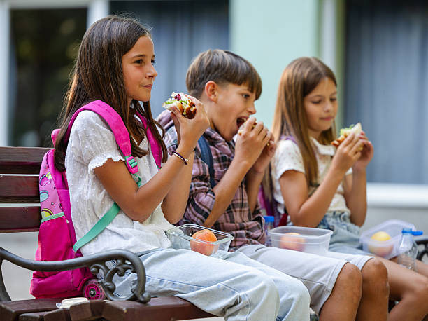istock Elementary school friends on a lunch break outdoors 2249907730