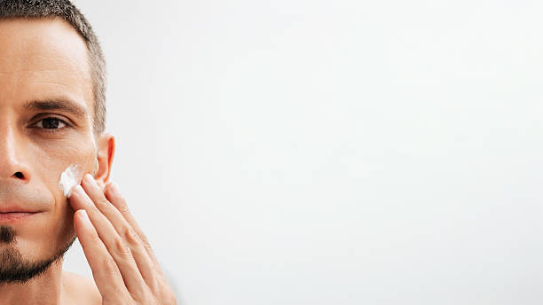 istock Male portrait with moisturizing cream on the cheek. 2249908520