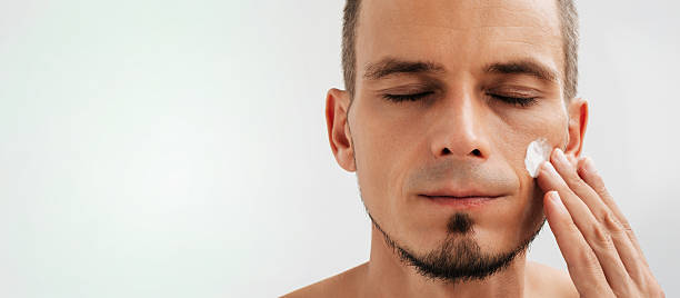 istock Male portrait with moisturizing cream on the cheek. 2249908534